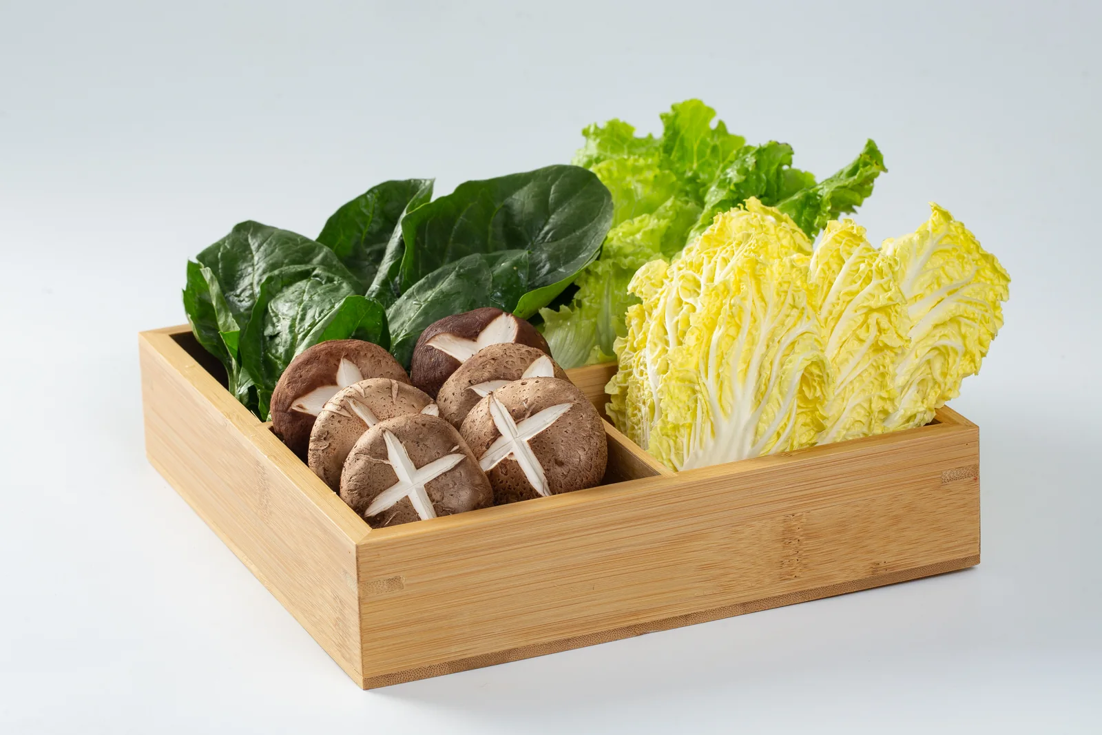 A basket full of leafy vegetables and mushrooms from the official Yang Guo Fu ingredient library